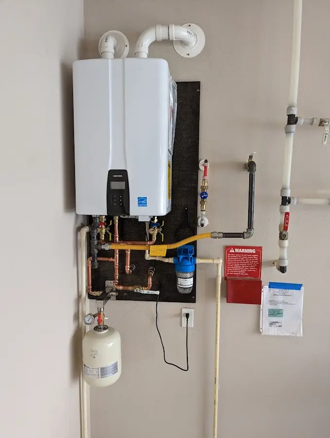 Professional plumber installing copper piping in a Waimanalo home